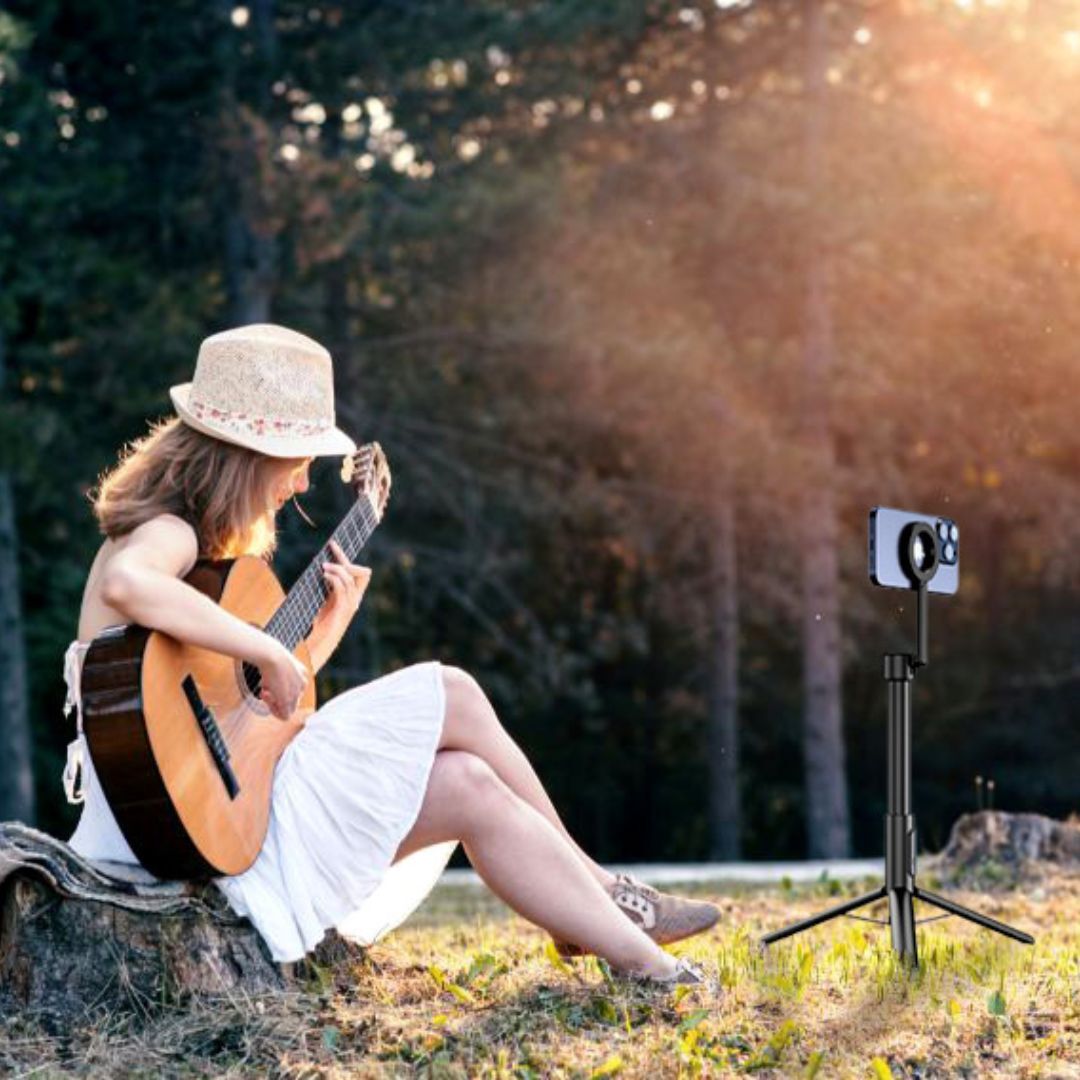 woman recording herself while playing guitar