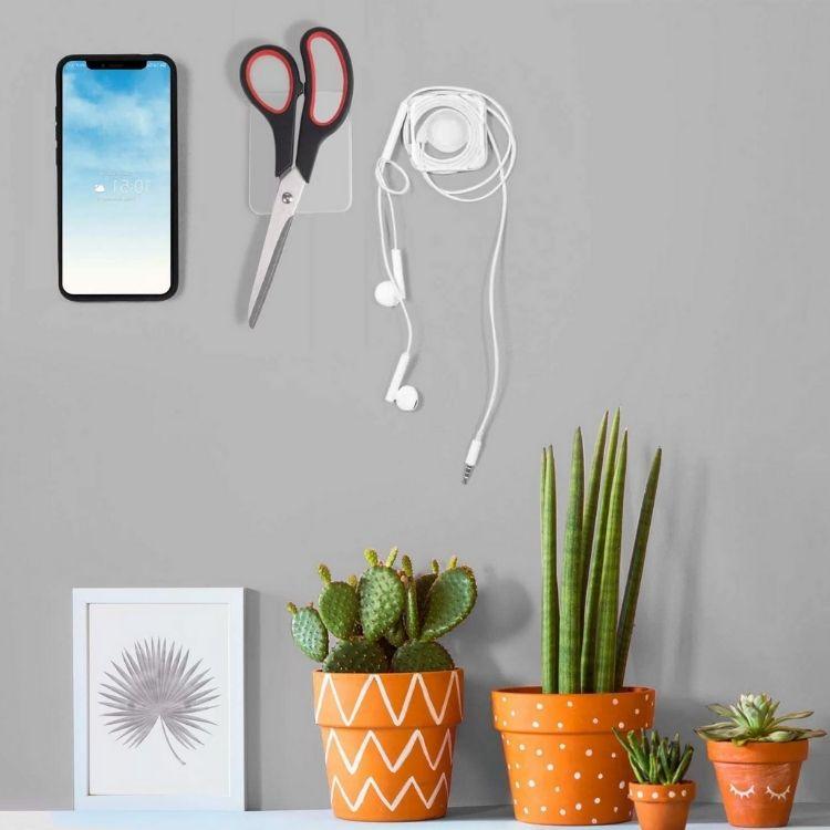 Sticky Gel Pad Phone Holder stick on the wall. Organize earphone wire and phone attached the wall