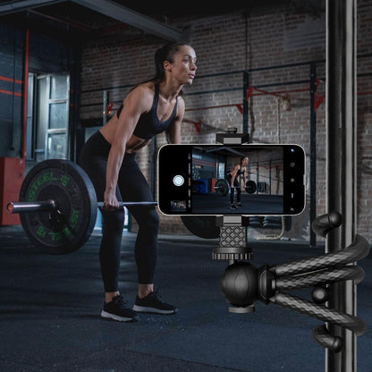 woman filming herself at the gym lifting weights