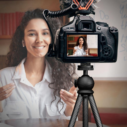 woman filming with flexible tripod attached to DSLR camera