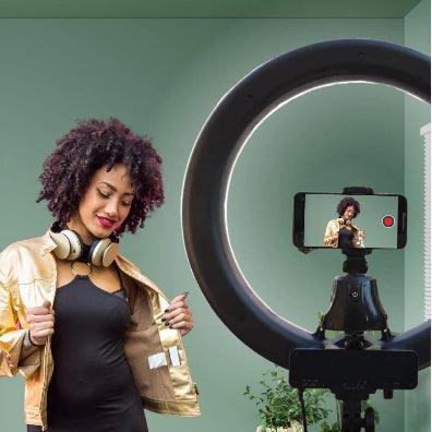 A woman with face tracker attach on ring light