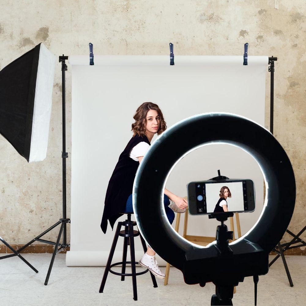 Adjustable white backdrop and support stand in photography studio